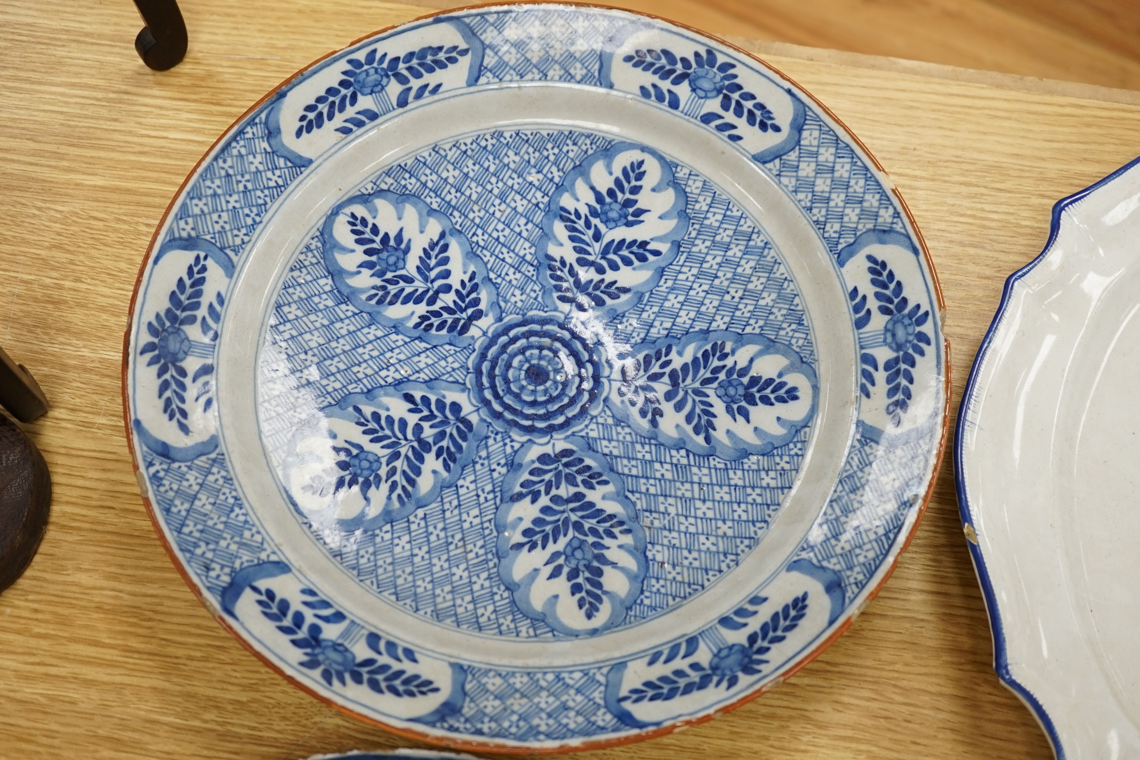 Four various continental delftware dishes, 18th and 19th century, largest 31cm diameter. Condition - various cracks and chipping to edges